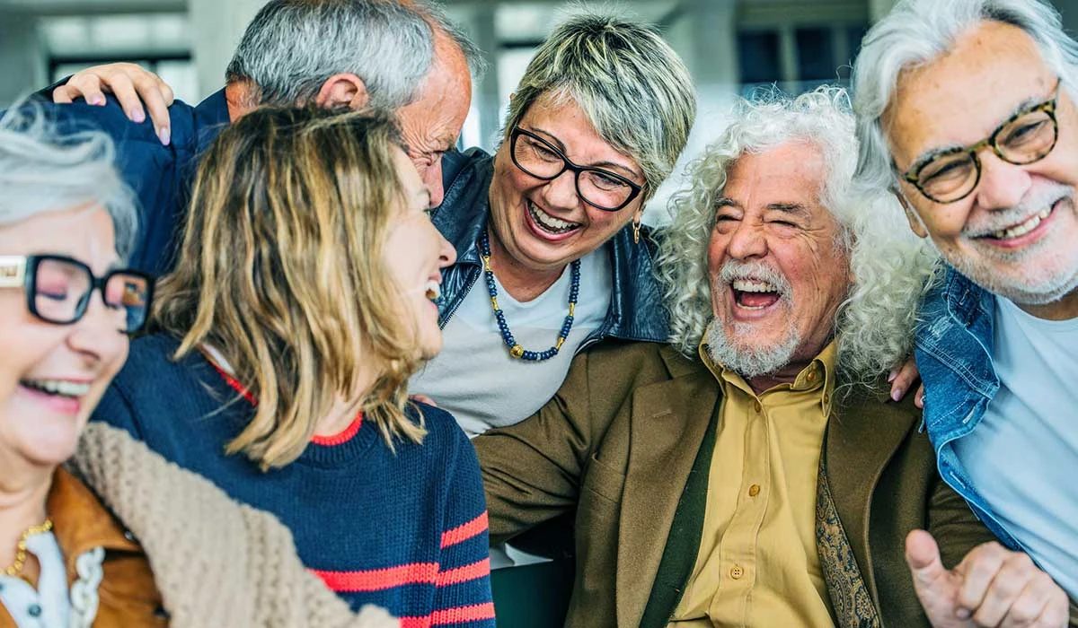 Happy seniors gathered in a group, embracing the joys of aging through friendship, laughter, and healthy living.