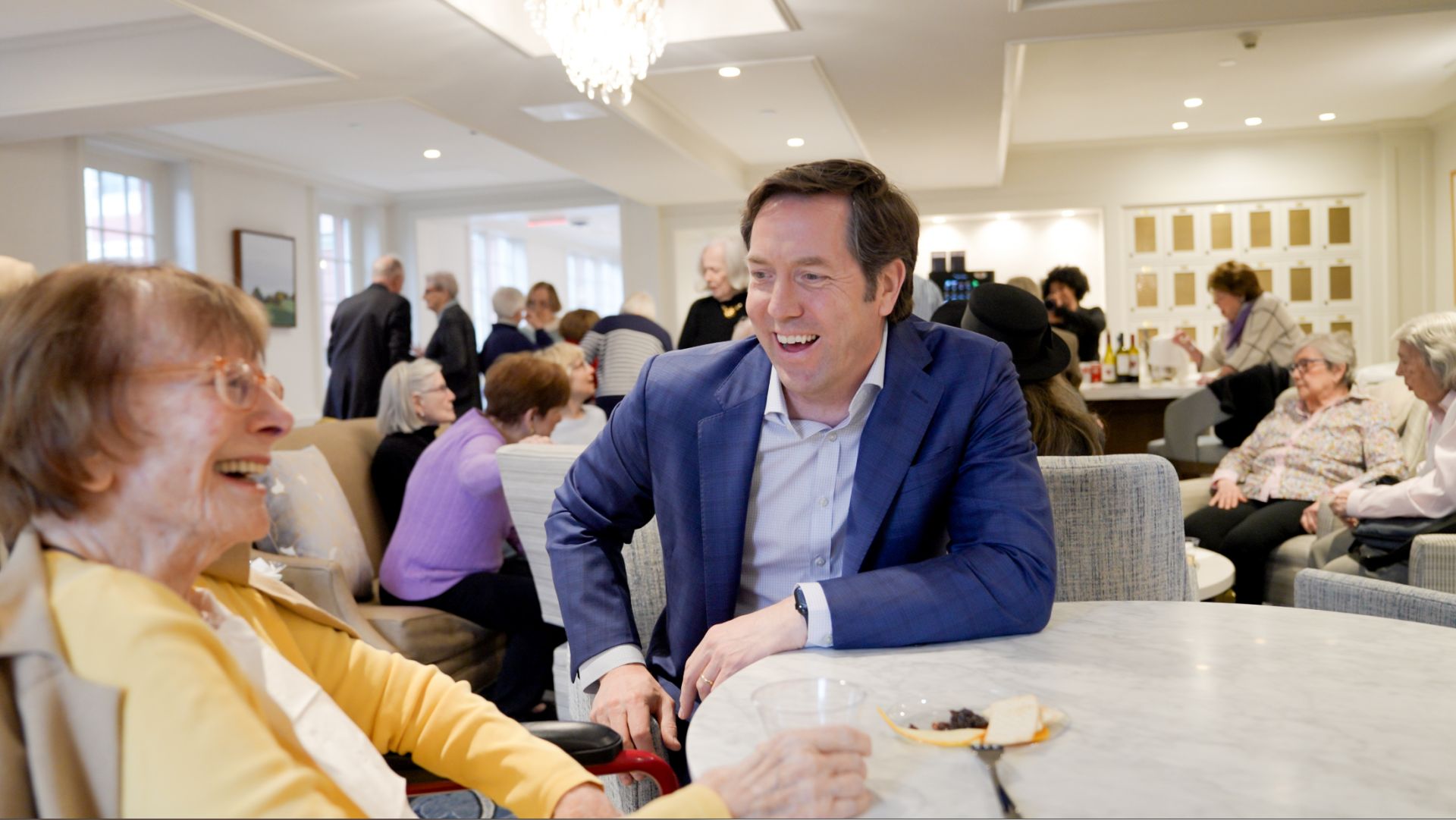 Matthew Anderson, CEO of The Osborn, greets a resident at a group gathering