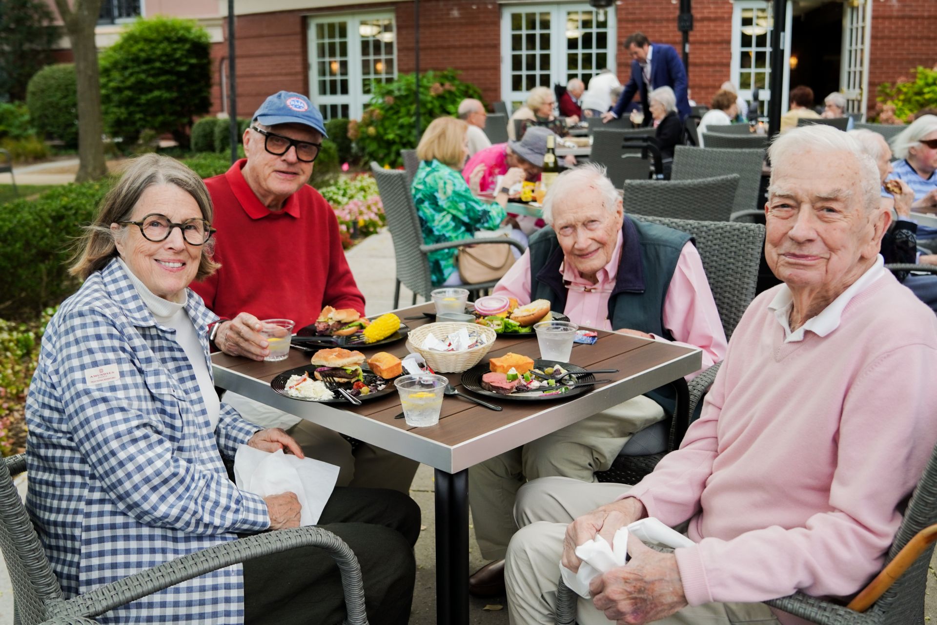 Residents of The Osborn dine in a group at an outdoor event