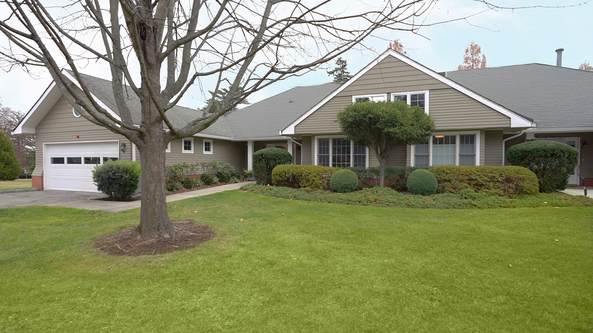 A Garden Home at The Osborn showcasing the landscaping and garage