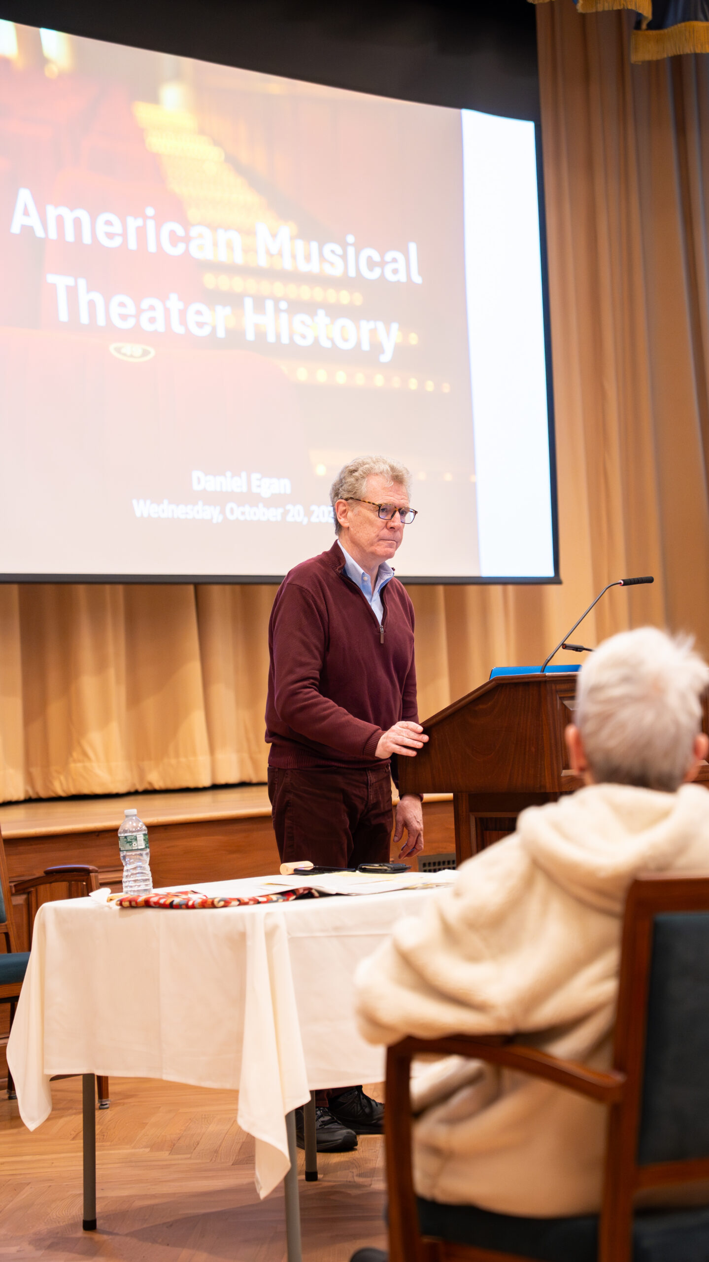 A guest speaker presenting an American Musical Theater History lecture to Osborn residents