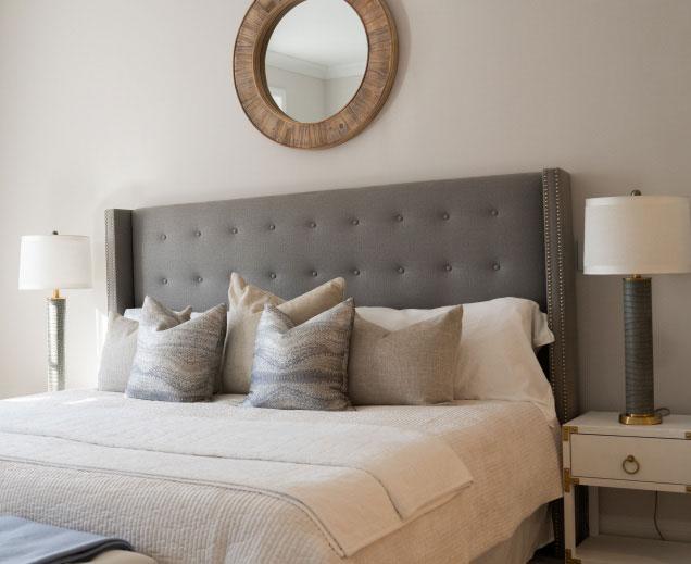 Elegantly furnished bedroom in a resident's apartment at The Osborn in Rye, NY, featuring a tufted headboard and cozy decor