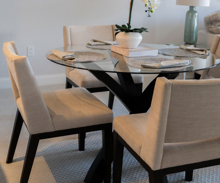 Dining area in a resident's apartment at The Osborn in Rye, NY, with a glass table set for two