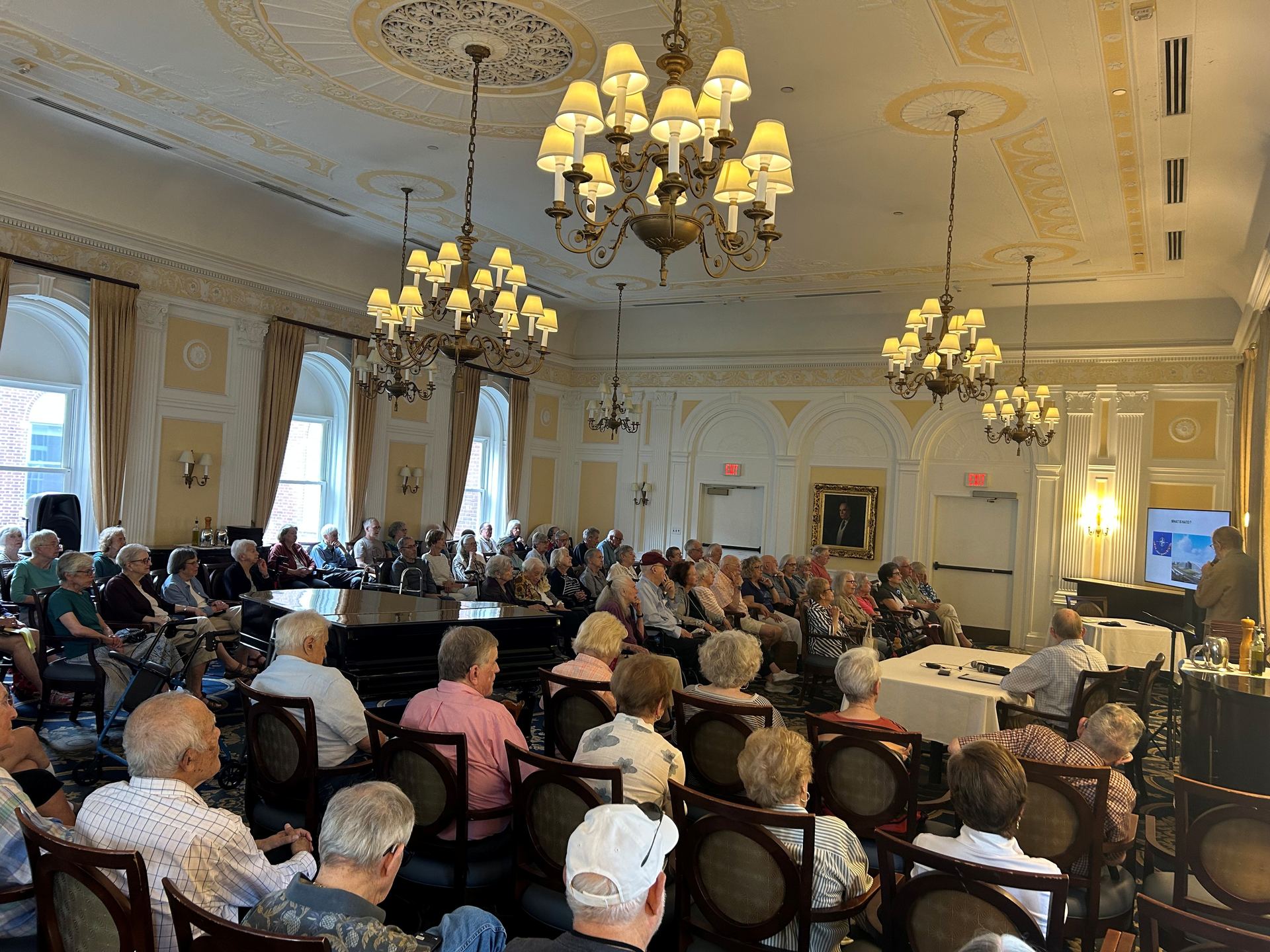 News & Views: Putting the World into Perspective Osborn residents fill a chandeliered hall for a News & Views presentation on NATO